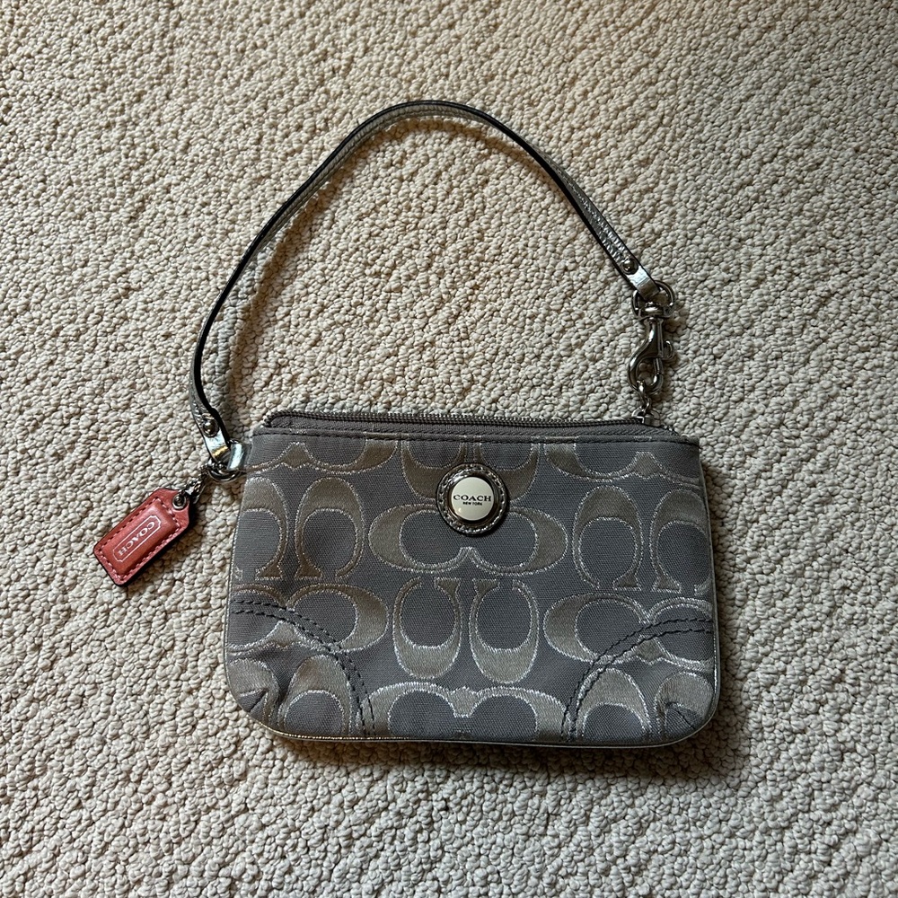 grey and silver coach wallet with pink detailing